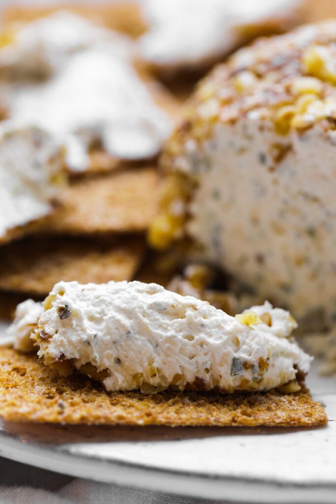 Premium Photo  Cheese balls with garlic and dill inside for a snack in a  white plate on a black background