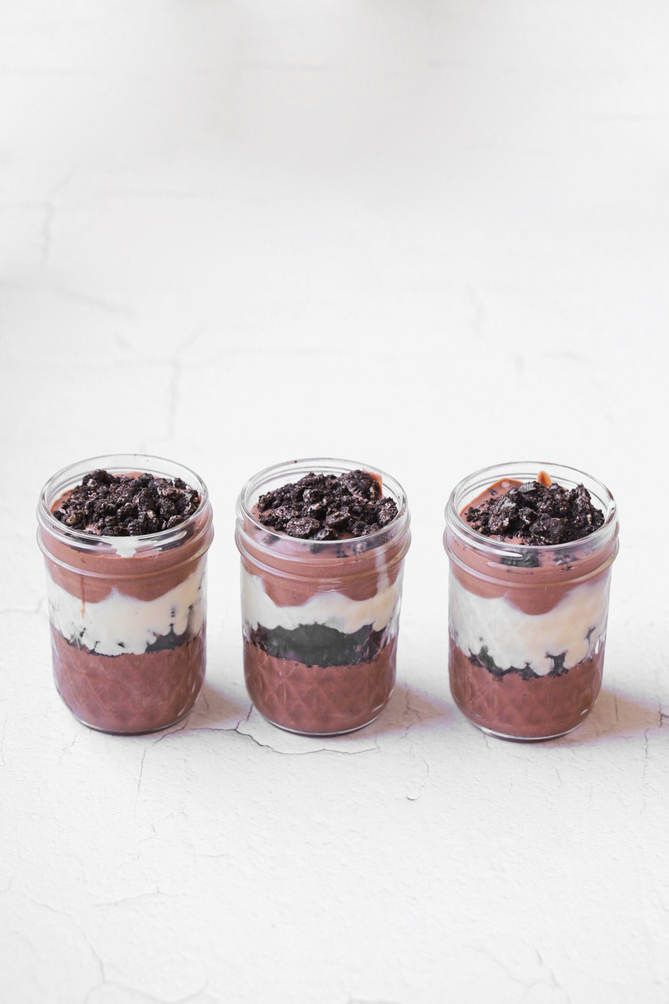 oreo pudding parfaits on a white background