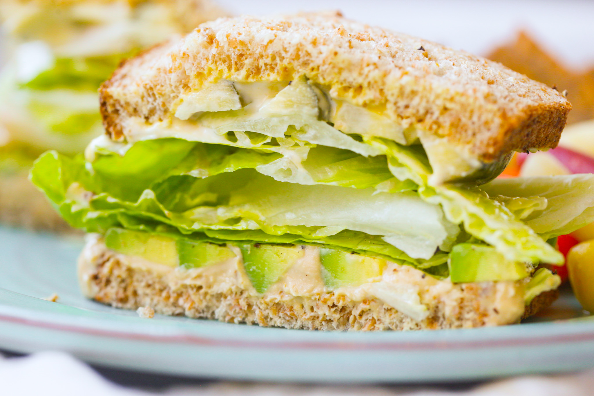 cut in half avocado lettuce sandwich