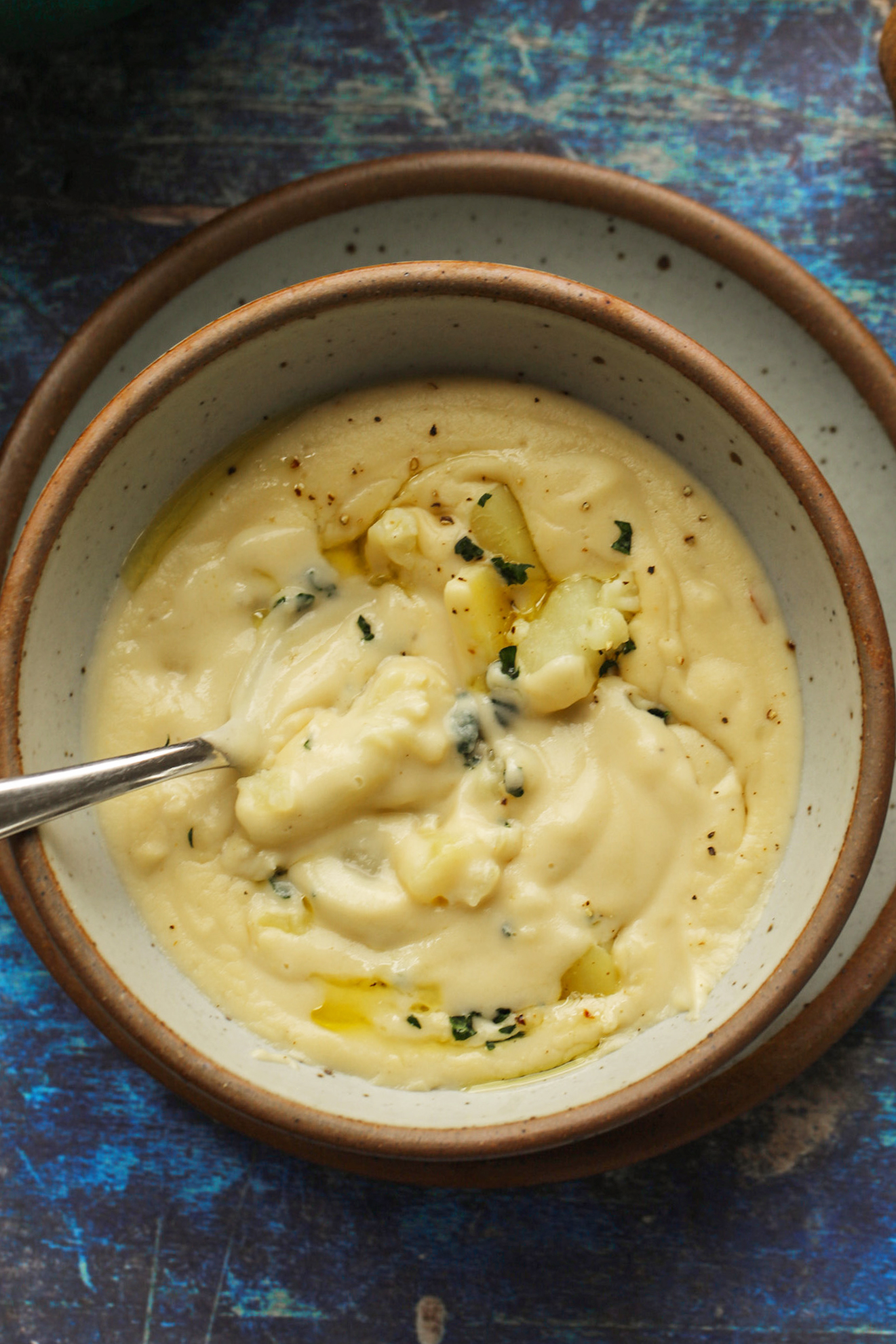 creamy cauliflower soup in white bowl