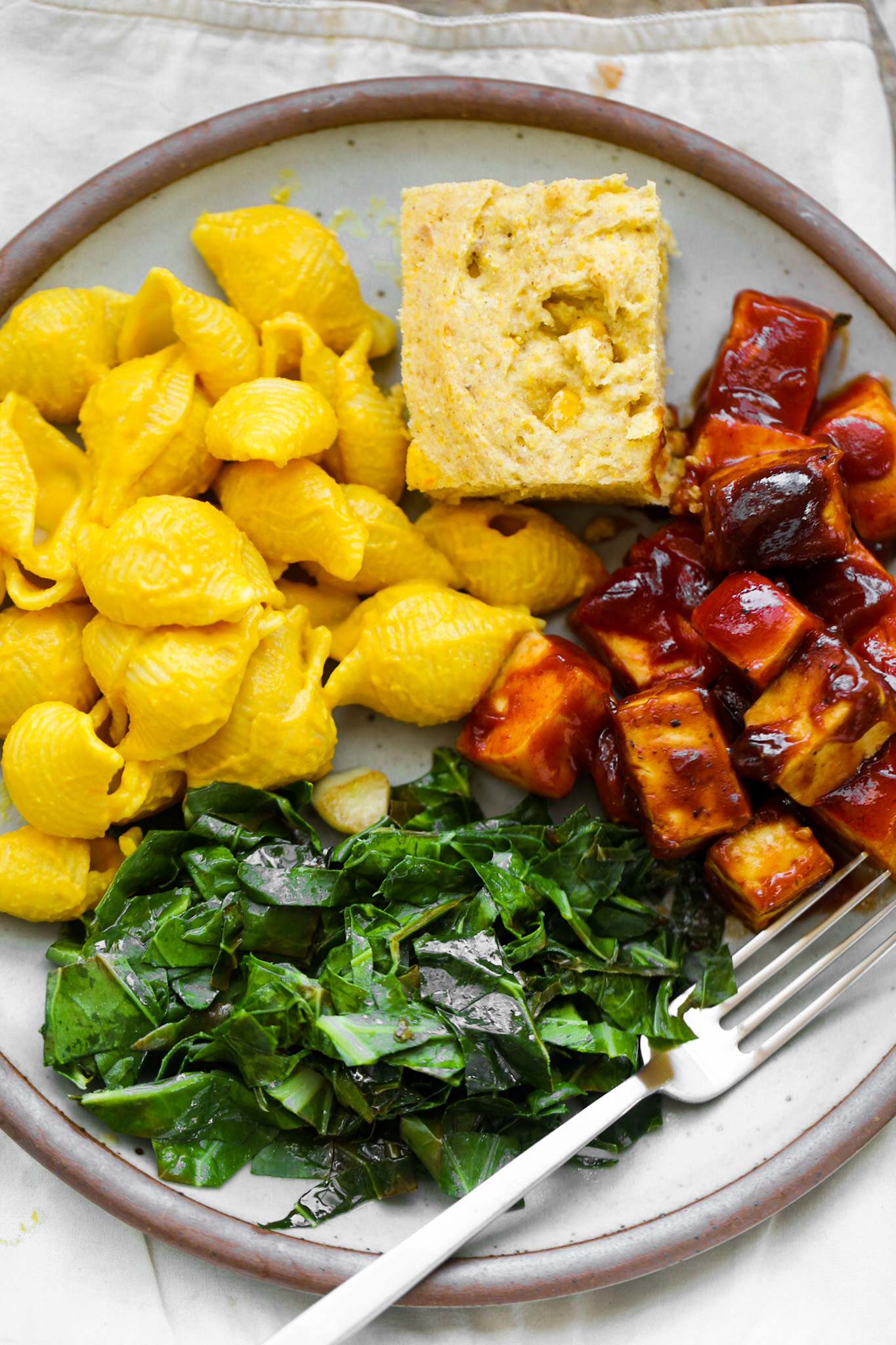 close up of collards, tofu and mac and cheese