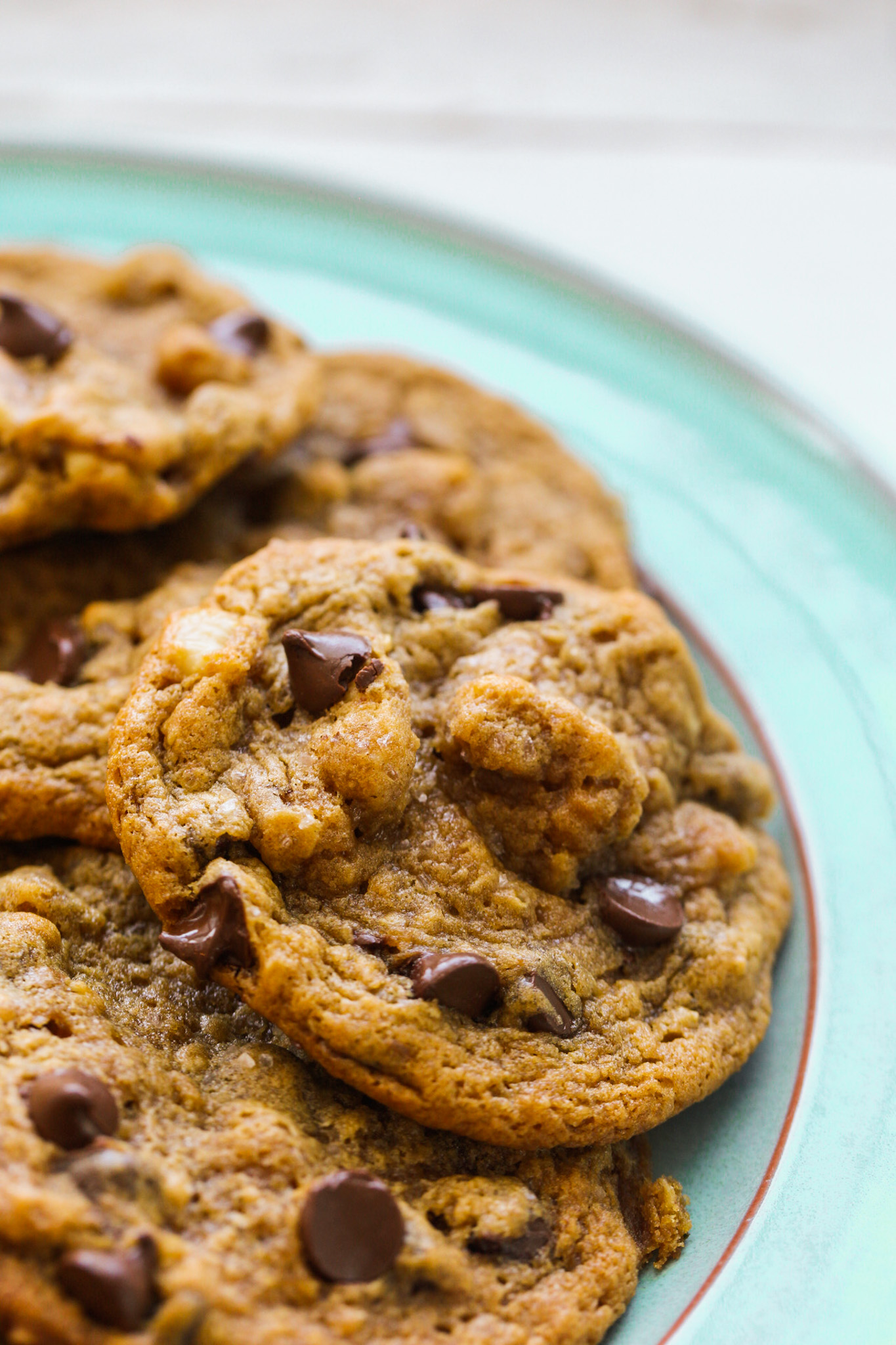 chewy chocolate chip cookies on teal plate