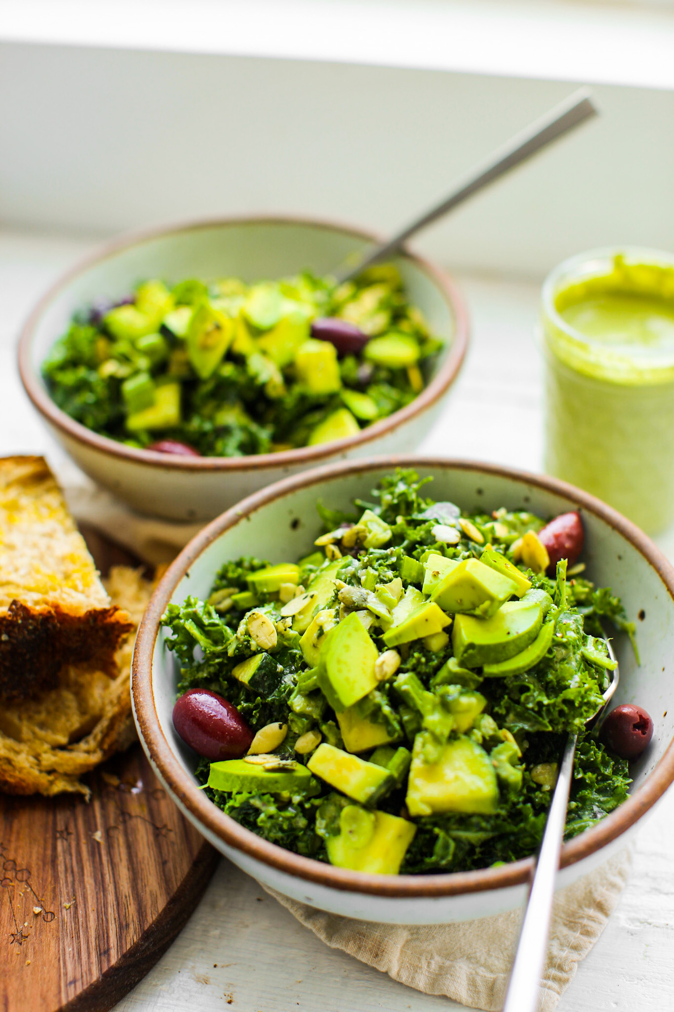 two vegan kale salads in bowls