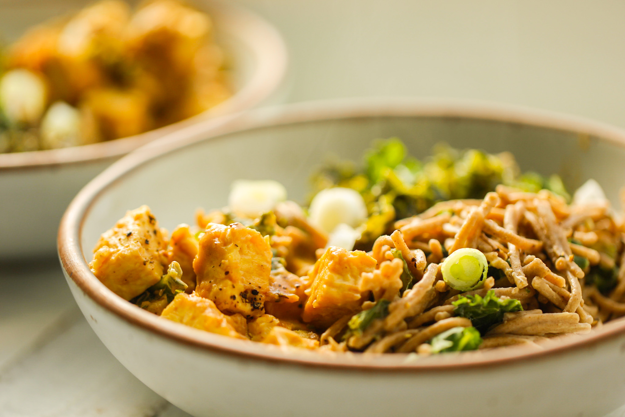 close up of peanut noodles with tempeh