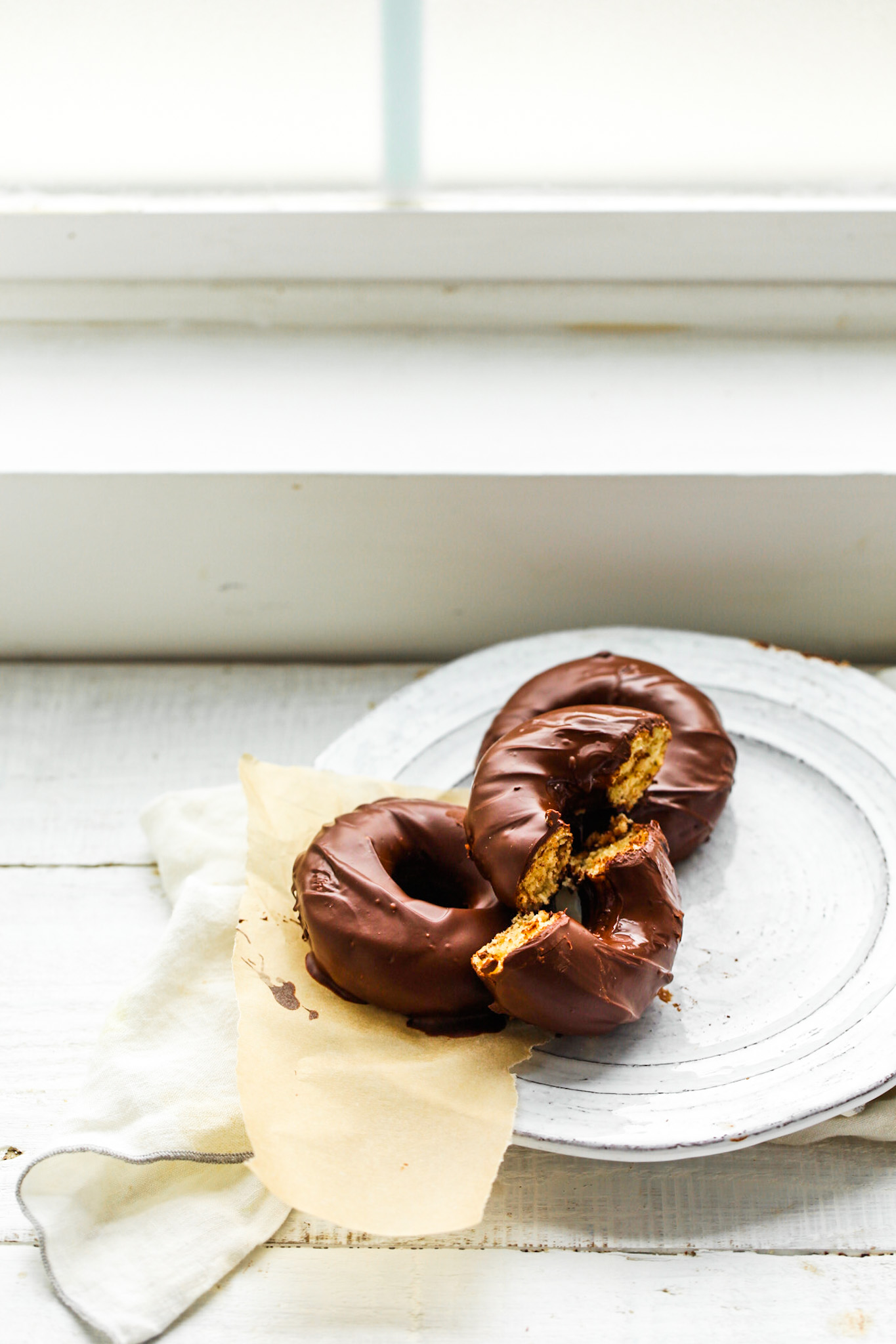 plate of chocolate frosted donuts