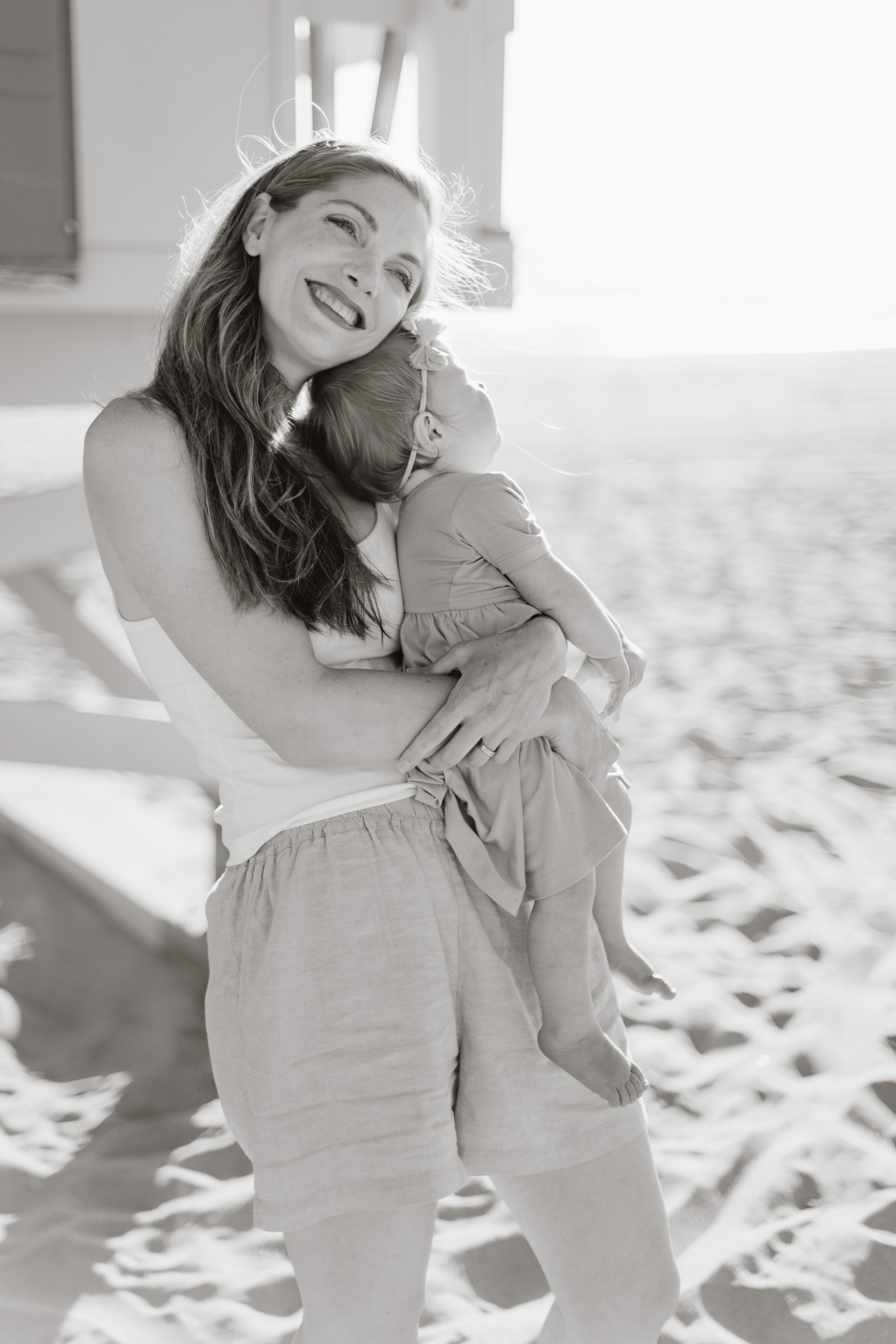 black and white mom baby on beach