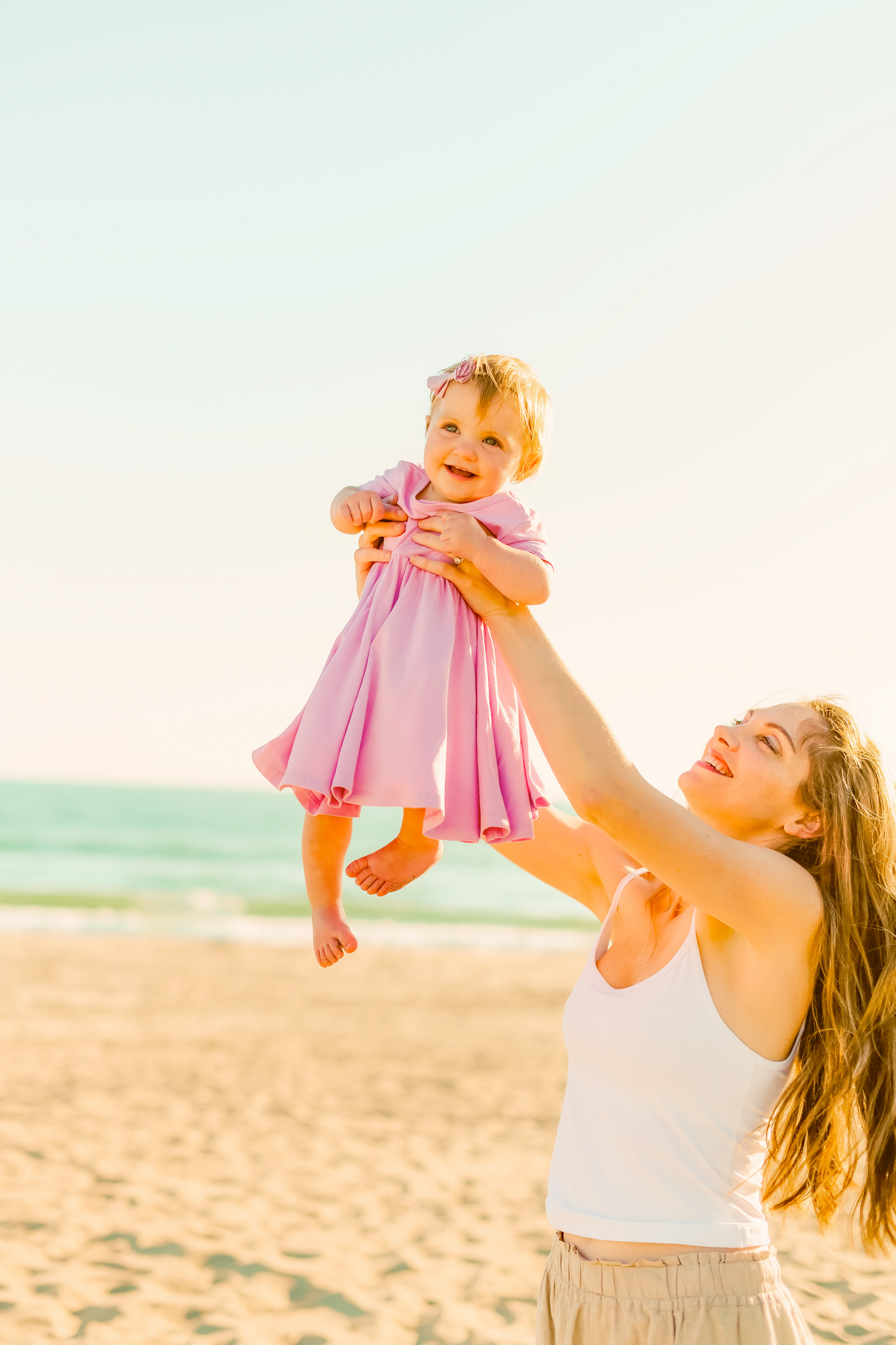 Rosalie in a pink dress baby beach