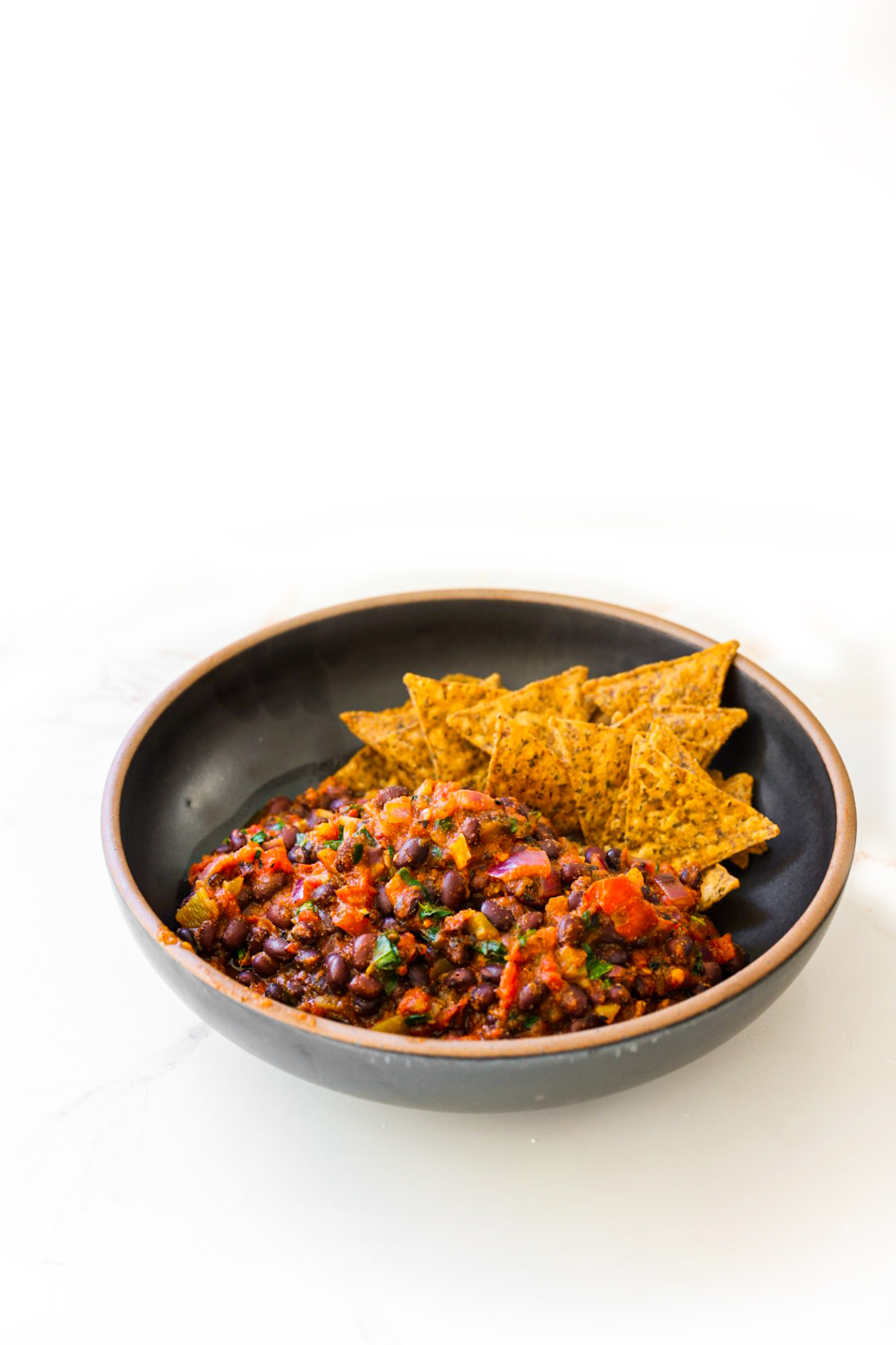 black beans in a bowl with chips