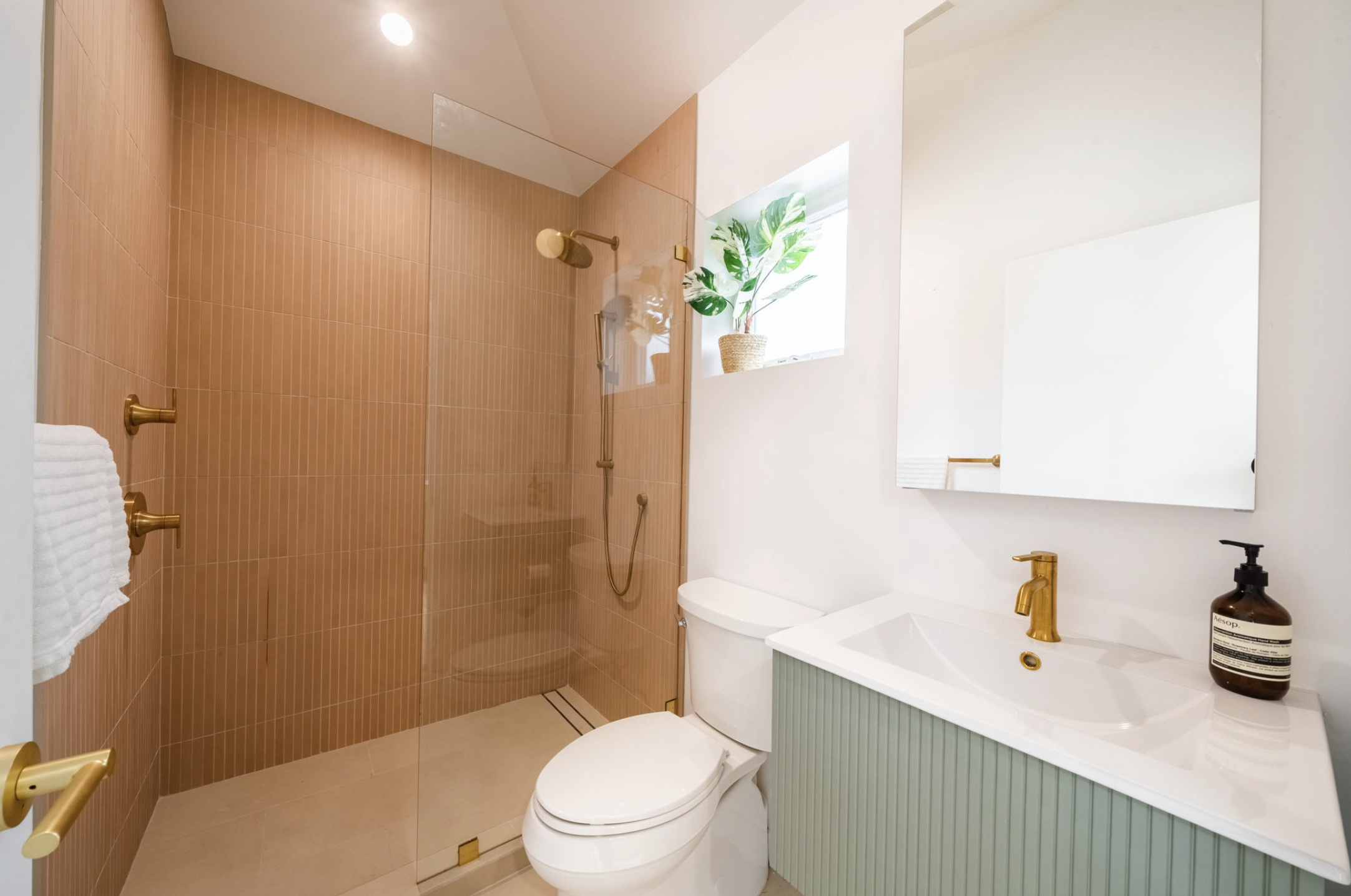 pink and green and gold bathroom modern