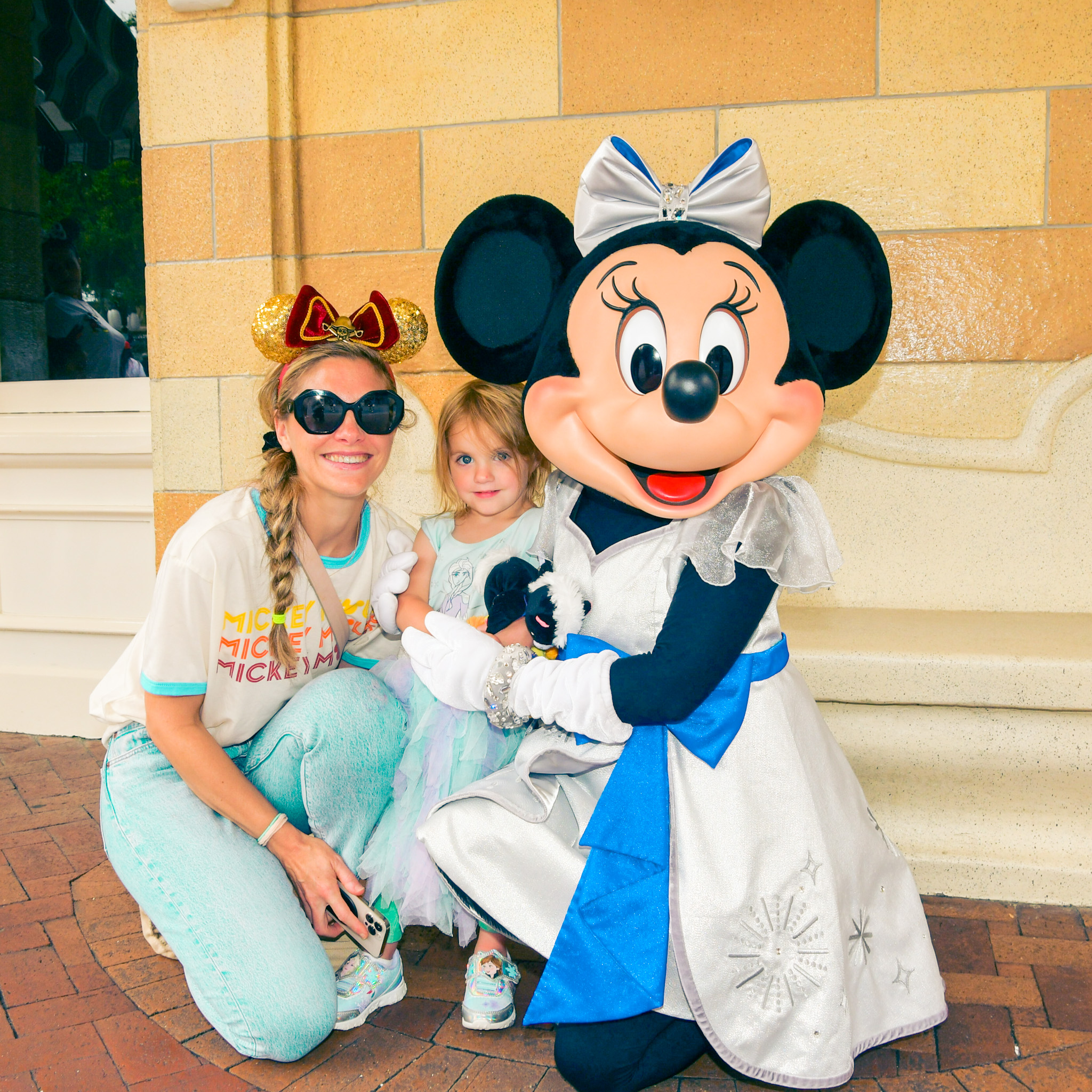 minnie mouse character and family photo at disneyland